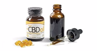 CBD oil supplement set with capsules, labeled bottle, dropper, and open tincture bottle on white background
