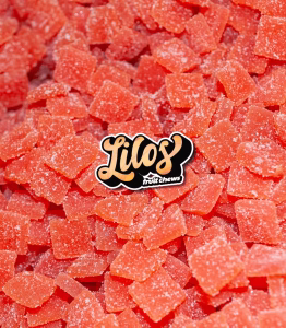 Pile of red sugar-coated fruit chews with a "Lilos Fruit Chews" logo in the center