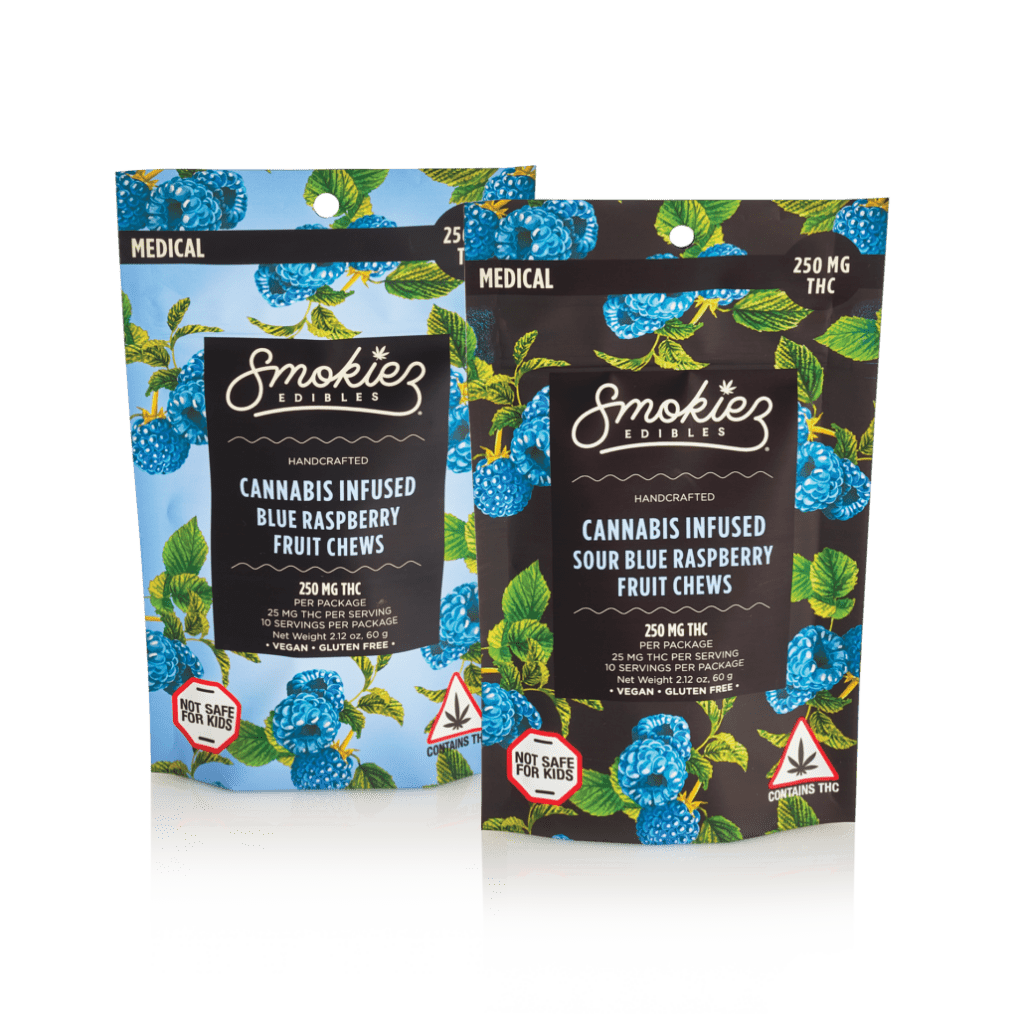 Two colorful packages of Smokiez Edibles cannabis-infused blue raspberry fruit chews, one regular and one sour flavor, each containing 250 mg THC and labeled with warnings about being unsafe for kids.