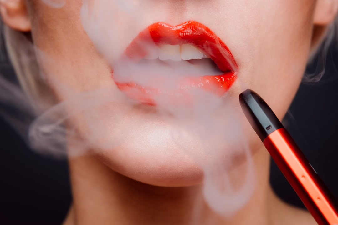 Red lipstick woman vaping electronic cigarette