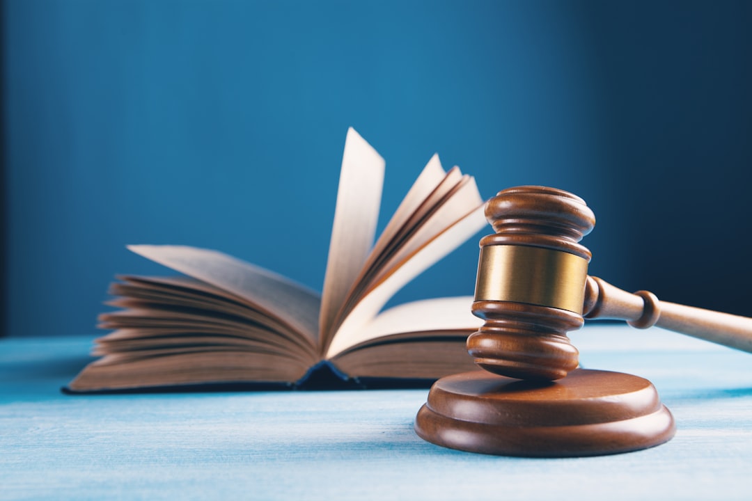 Law book and judge gavel on table