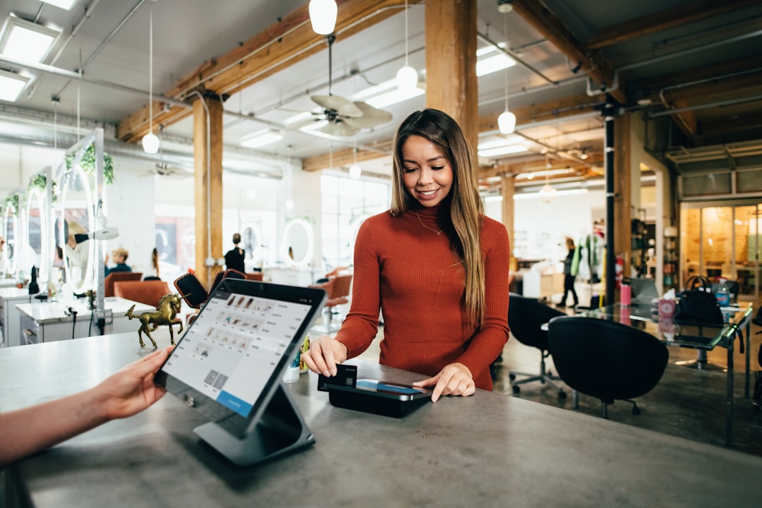 Woman paying at salon POS terminal counter