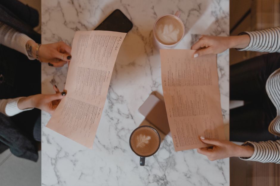 above view of two people holding menus